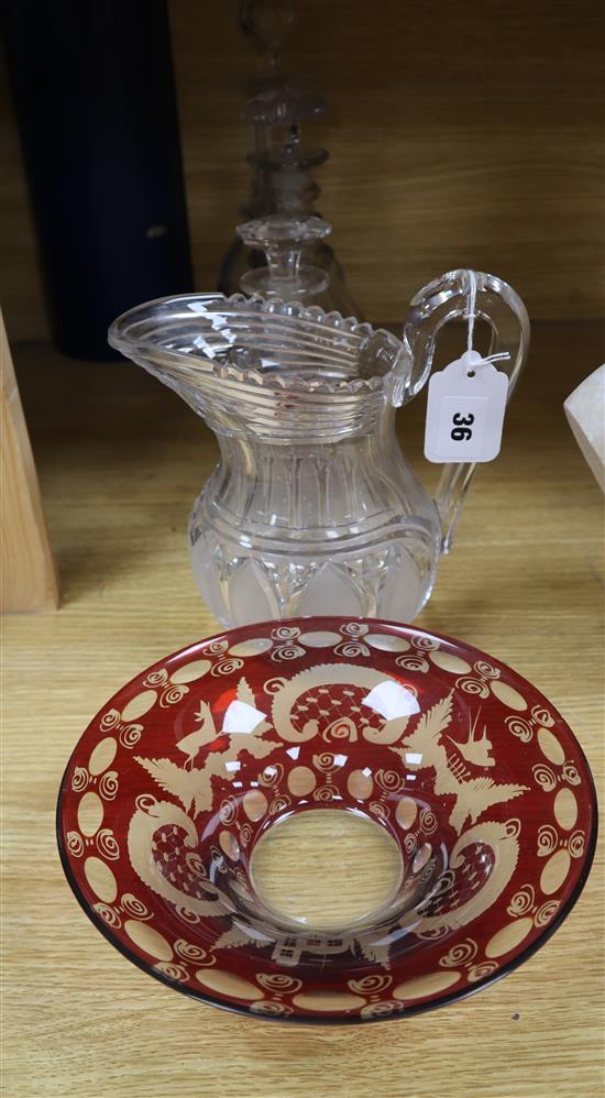 An early Victorian glass water jug, three Regency decanters and a Bohemian ruby glass bowl (5)